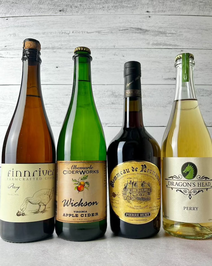 three 750 mL bottles of ciders and one 750mL bottle of Pieerre Huet Pommeau de Normandie
