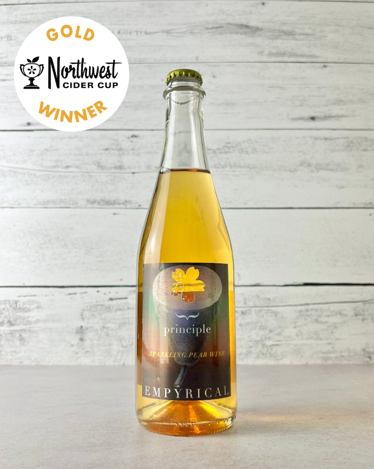 Photo of a bottle of Empyrical Cider's Principle Perry on kitchen counter, with the Northwest Cider Cup Gold Medal