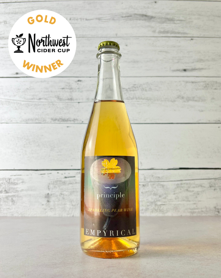 Photo of a bottle of Empyrical Cider's Principle Perry on kitchen counter, with the Northwest Cider Cup Gold Medal