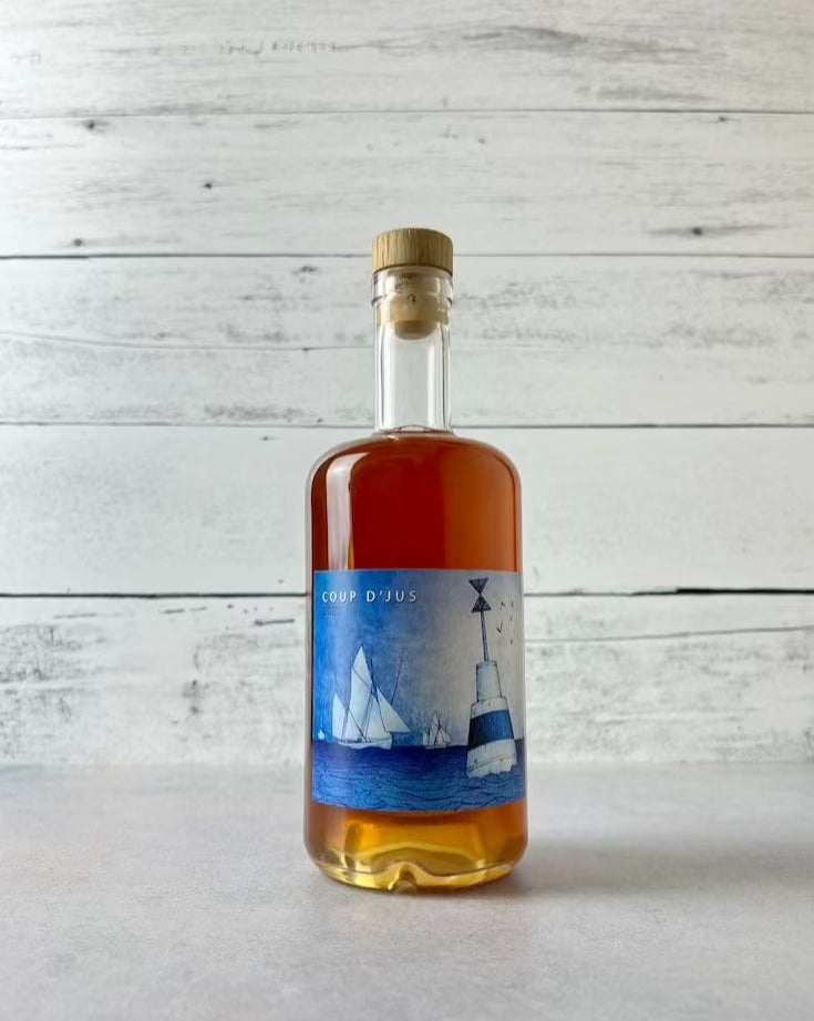 clear bottle of Ferme de Port Coustic Coup d'Jus Pommeau de Bretagne - Brittany pommeau aperitif cider