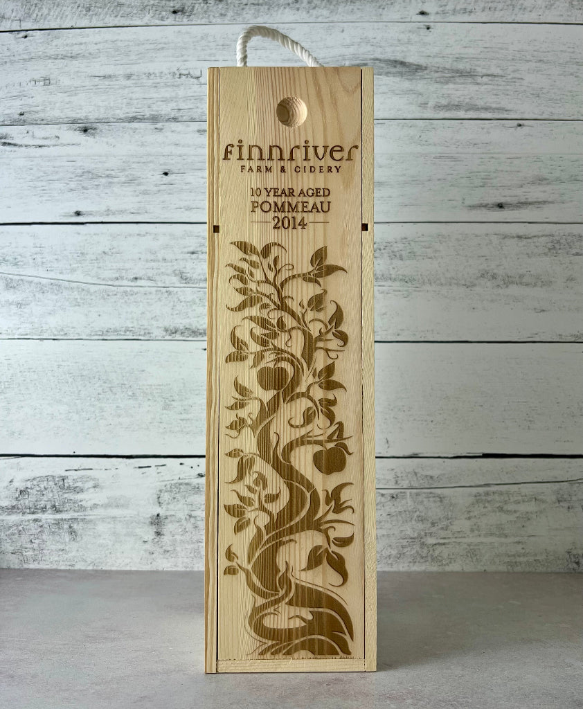 Photo of a wooden wine box that states, "Finnriver Farm & Cidery 10 Year Aged Pommeau 2014"