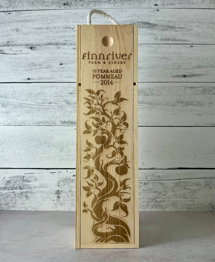 Photo of a wooden wine box that states, "Finnriver Farm & Cidery 10 Year Aged Pommeau 2014"