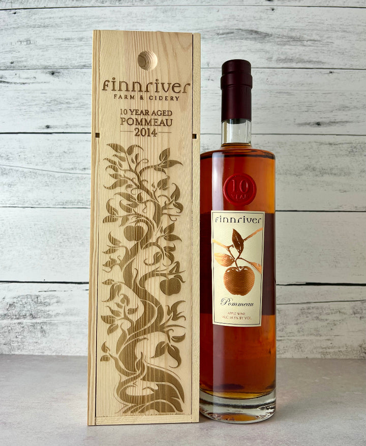 Photo of a Finnriver Cidery 750 mL bottle of 10 Year Pommeau and wooden box that states, "Finnriver Farm & Cidery 10 Year Aged Pommeau 2014"