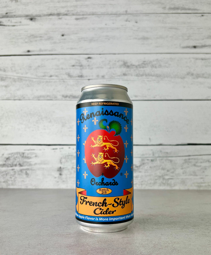 A photo of a 16 oz can of Renaissance Orchards Keeved Cider with a label showing an apple illustration and text, placed against a wooden backdrop. There is a badge on the top left corner indicating 'Silver Northwest Cider Cup Winner'.