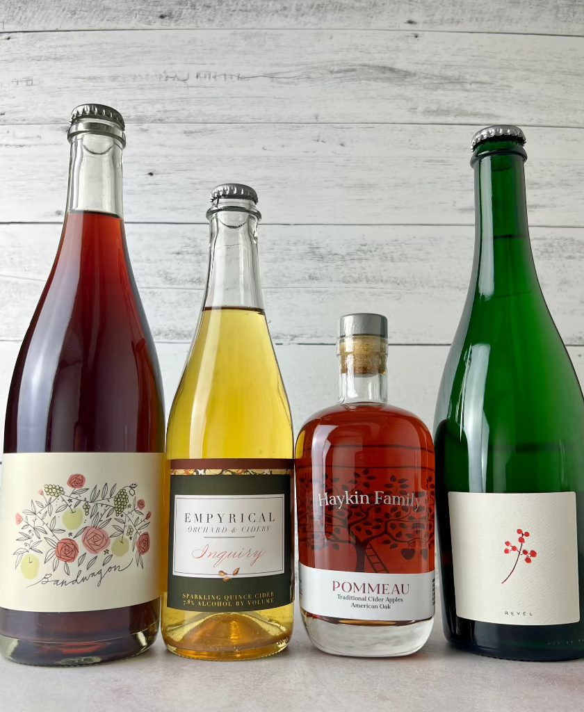 4 bottles of cider: Rose Hill Farm, Empyrical Cider, Haykin Family Cider Pommeau, and Revel Cider