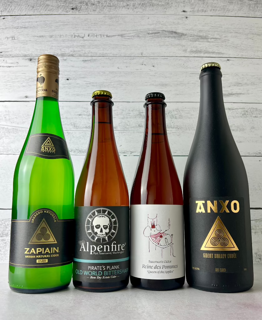4 bottles of cider: Zapiain, Alpenfire, Bauman's Cider, and Anxo Cider
