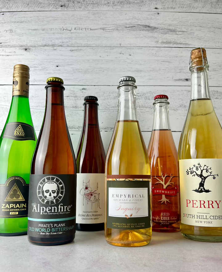 6 bottles of cider, including Zapian, Alpenfire, Bauman's Cider, Empyrical Cider, Snowdrift Cider, and South Hill Cider