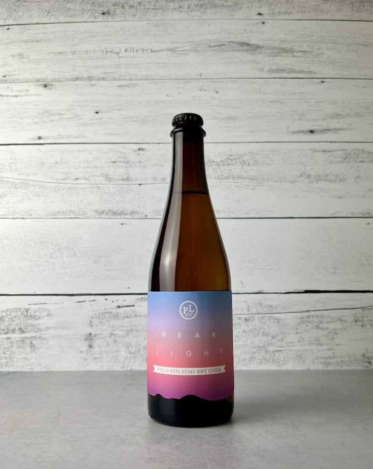 500 mL bottle of Peak Light Cider Field Run Semi-Dry Cider