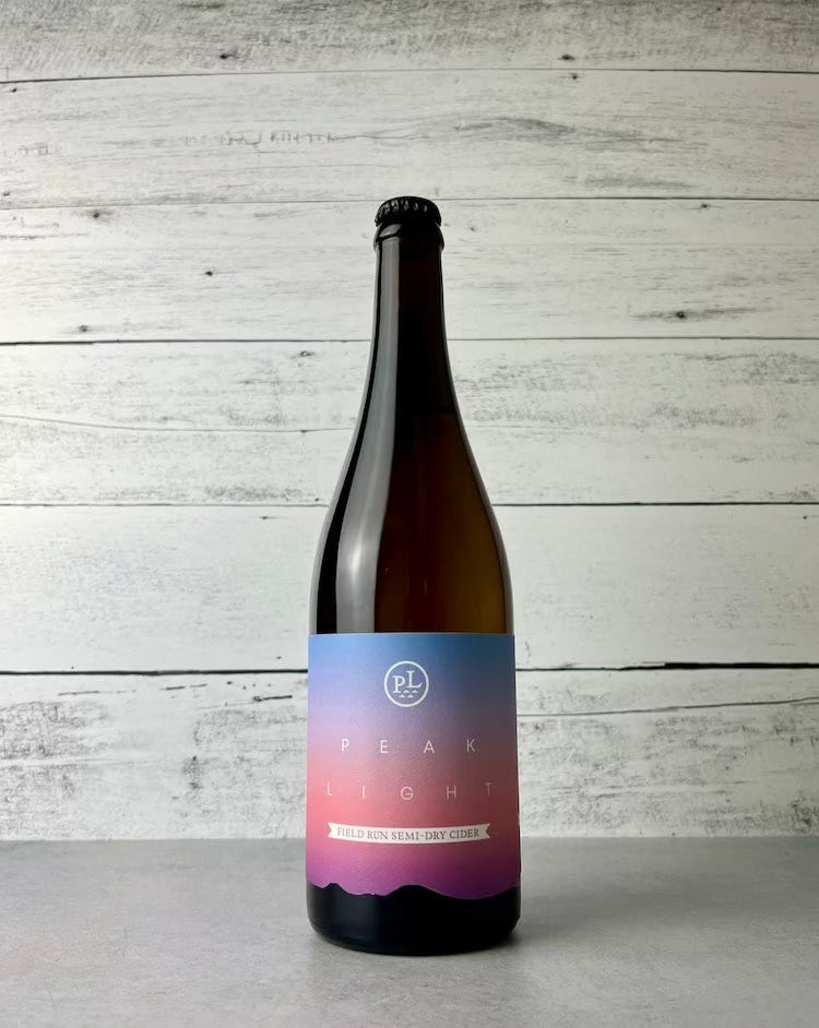 750 mL bottle of Peak Light Field Run Semi-Dry Cider