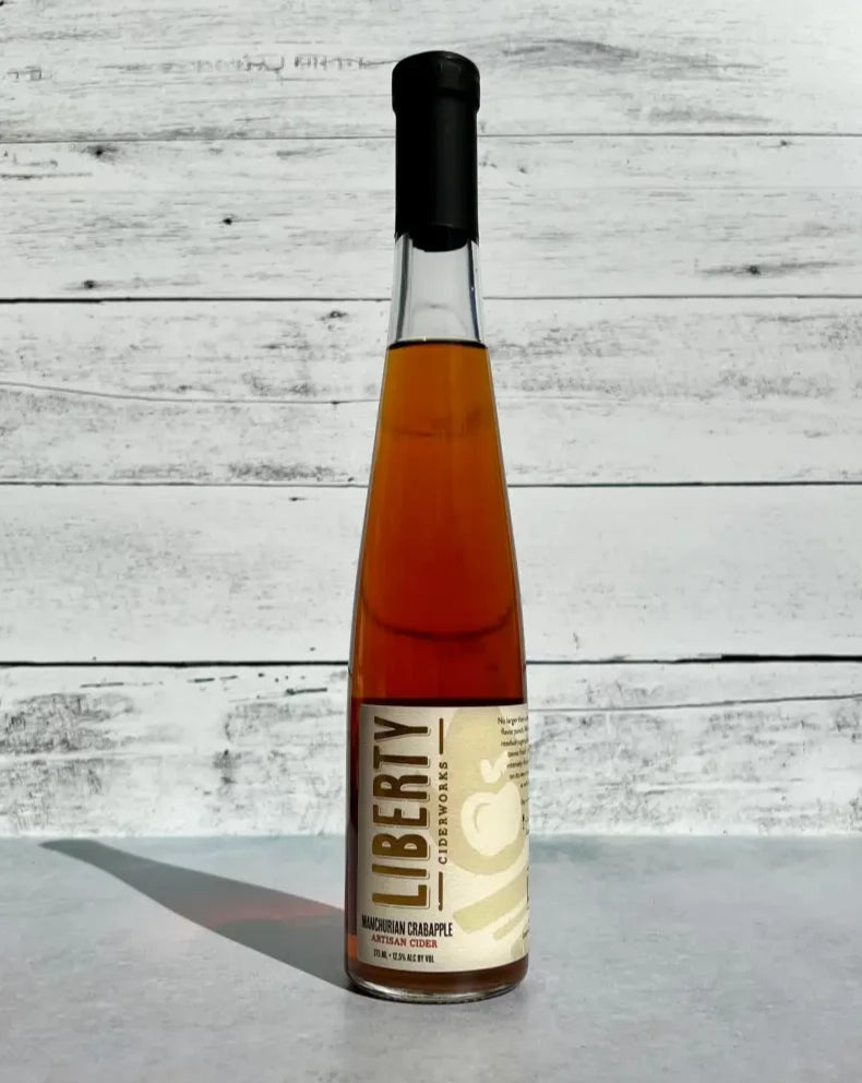 375 mL clear glass bottle of Liberty Ciderworks Manchurian Crabapple Artisan Cider