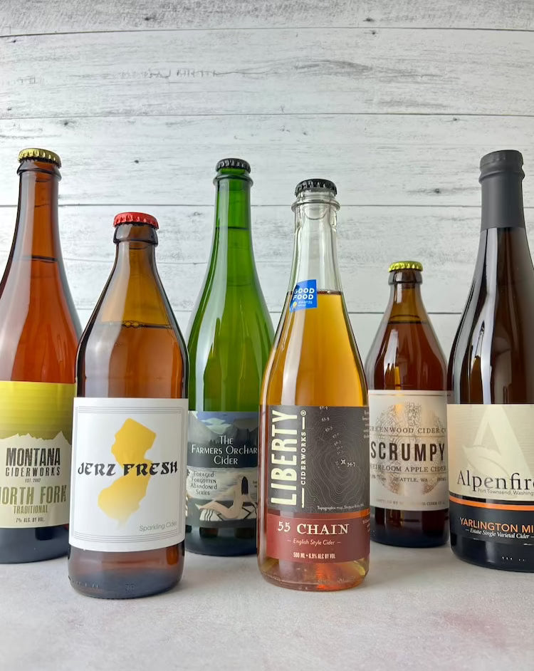 6 bottles of cider: Montana Ciderworks North Fork, Durham Jerz Fresh, Botanist & Barrel The Farmer's Orchard, Liberty Ciderworks 55 Chain, Greenwood Cider Scrumpy, Alpenfire Yarlington Mill