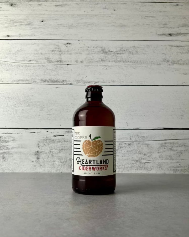 12 oz bottle of Heartland Ciderworks The Cooper cider