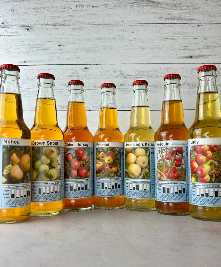 7 bottles of single-varietal ciders: Nehou, Brown Snout, Chisel Jersey, Bramtot, Ashmead's Kernel, Frequin (not Frequin Rouge), and Lady
