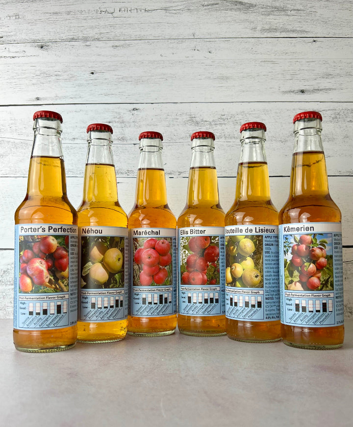 6 bottles of single varietal ciders: Porter's Perfection, Nehou, Marechal, Ellis Bitter, Bouteille de Lisieux, and Kemerien