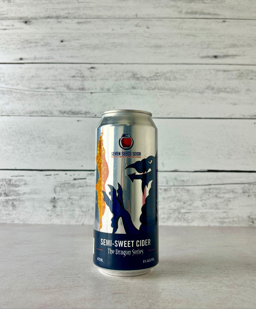 Photo of 16 oz Can of Seven Seeds Seidr The Dragon Series semi-sweet cider with a dragon design on a white wooden background