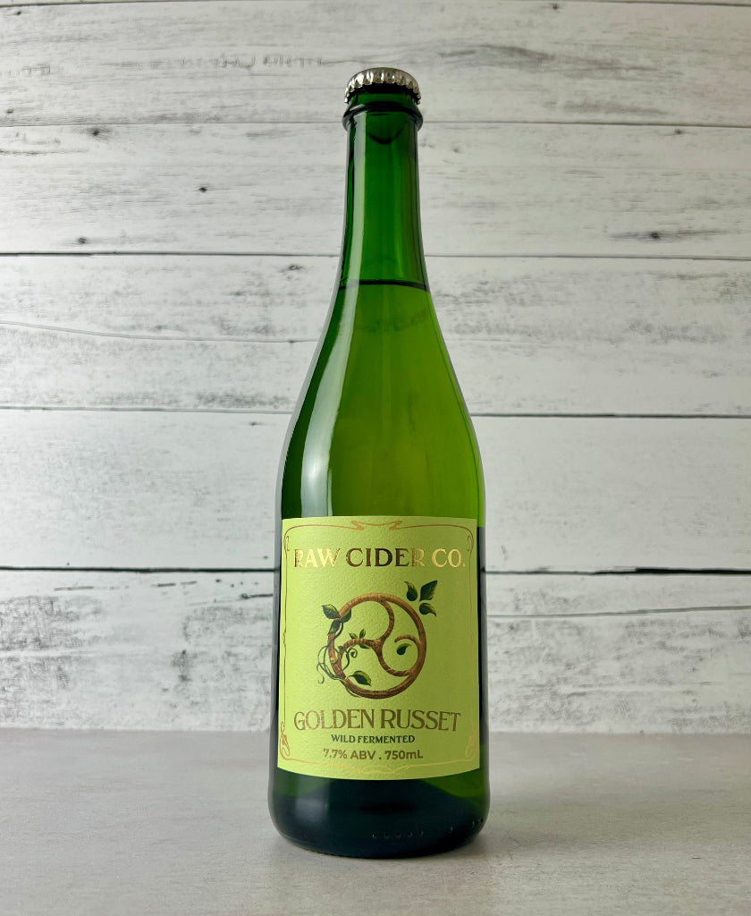 Photo of a 750 mL green glass bottle of Raw Cider Co. Golden Russet Wild Fermented cider