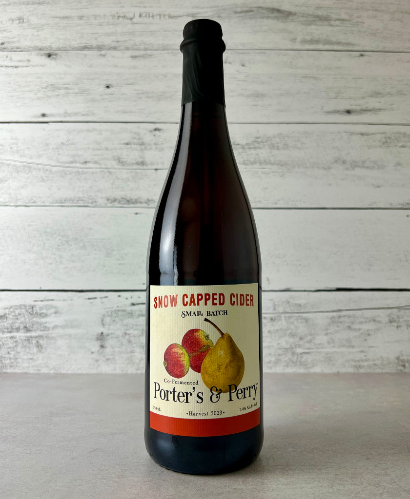 Photo of a 750 mL bottle of Snow Capped Cider Small Batch Co-Fermented Porter's & Perry