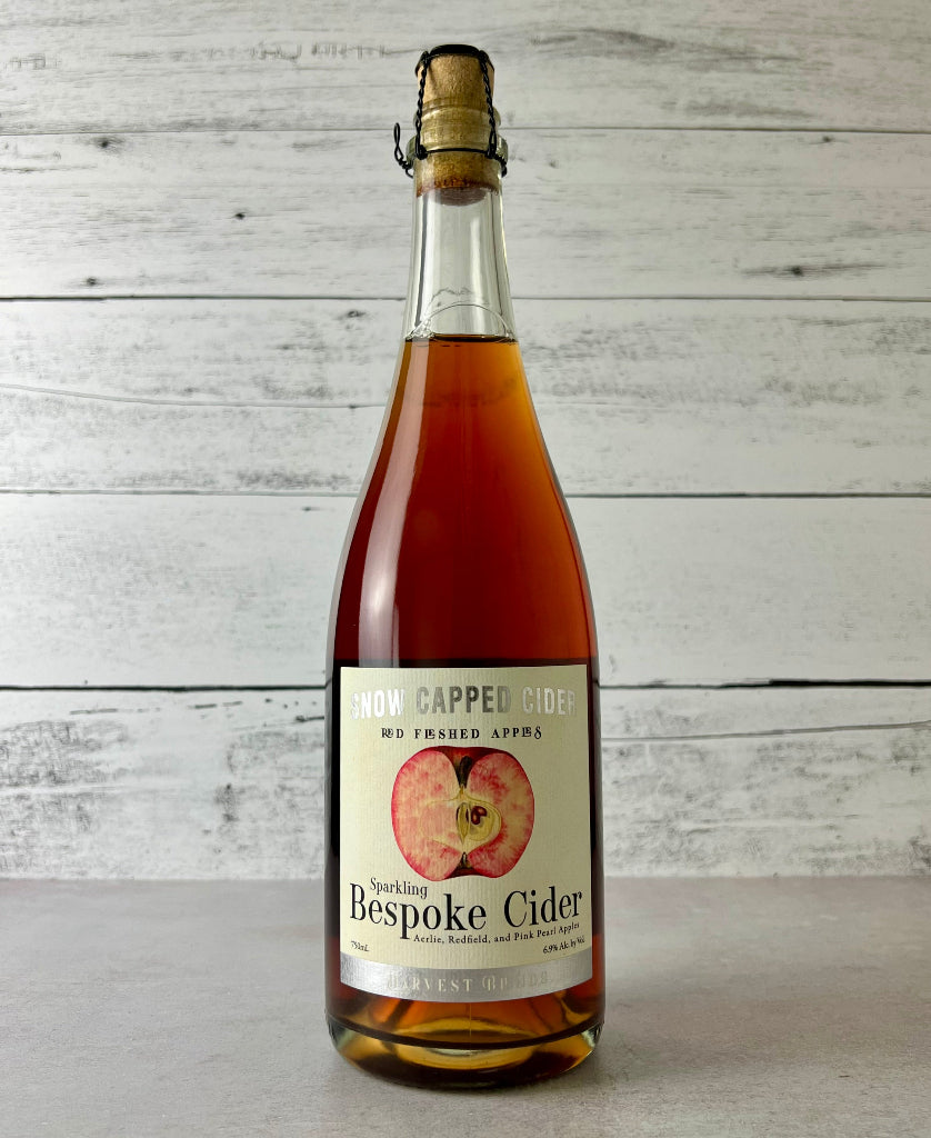 Photo of a 750 mL bottle of Snow Capped Cider Red Fleshed Apples - Sparkling Bespoke Cider - Aerlie, Redfield, and Pink Pearl Apples