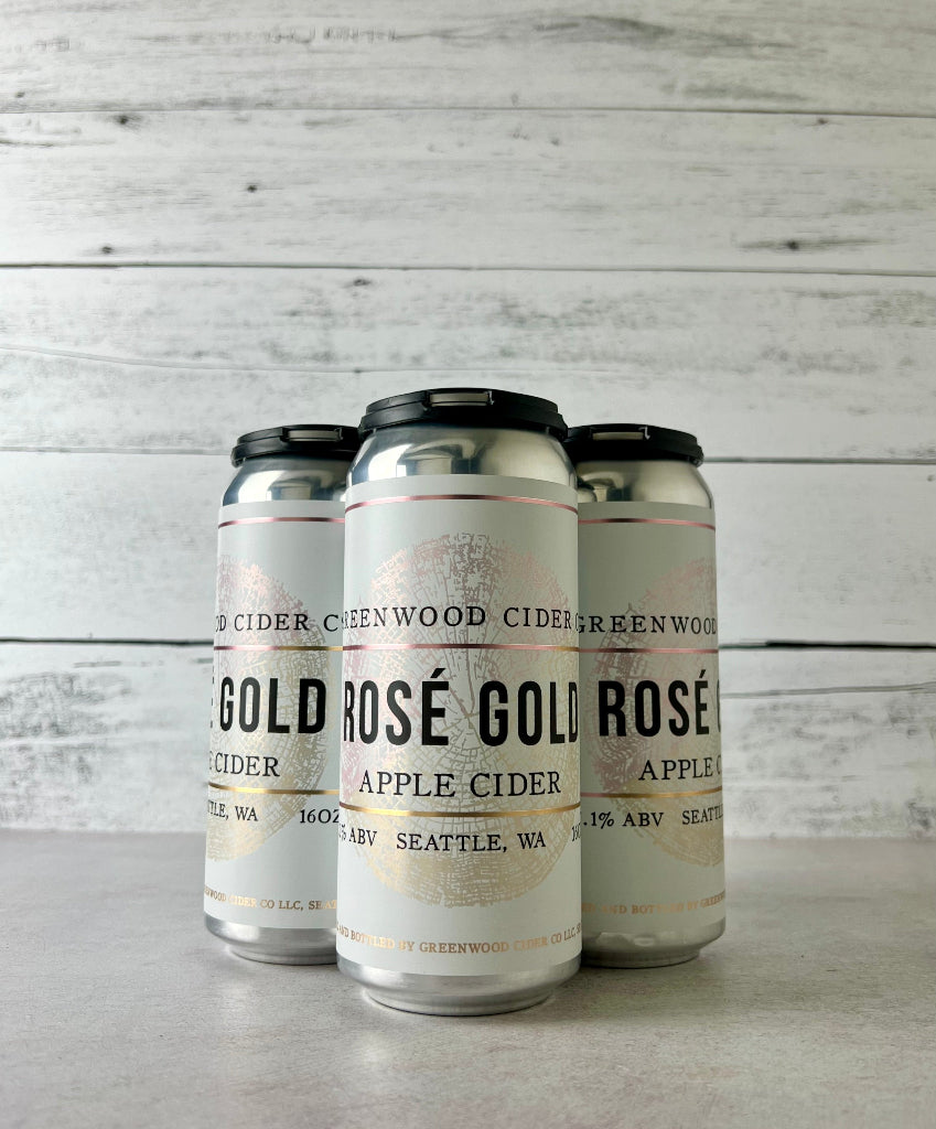 Photo of a 4-pack of 16 oz cans of Greenwood Cider Rosé Gold Apple Cider