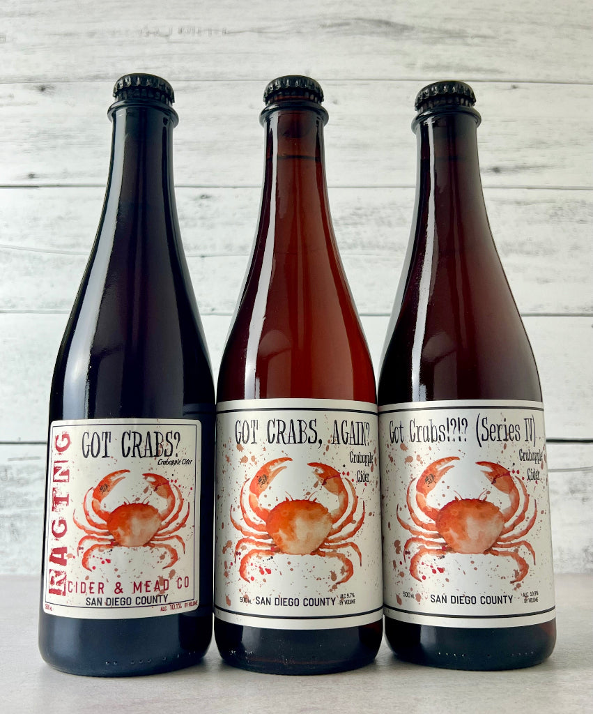 Photo of three 500 mL bottles of Raging Cider & Mead Co. Ciders: Got Crabs?, Got Crabs Again?, and Got Crabs!?!? Series IV