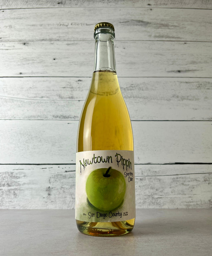 Photo of a 750 mL bottle of Raging Cider & Mead Co. Newtown Pippin Sparkling Cider - San Diego County