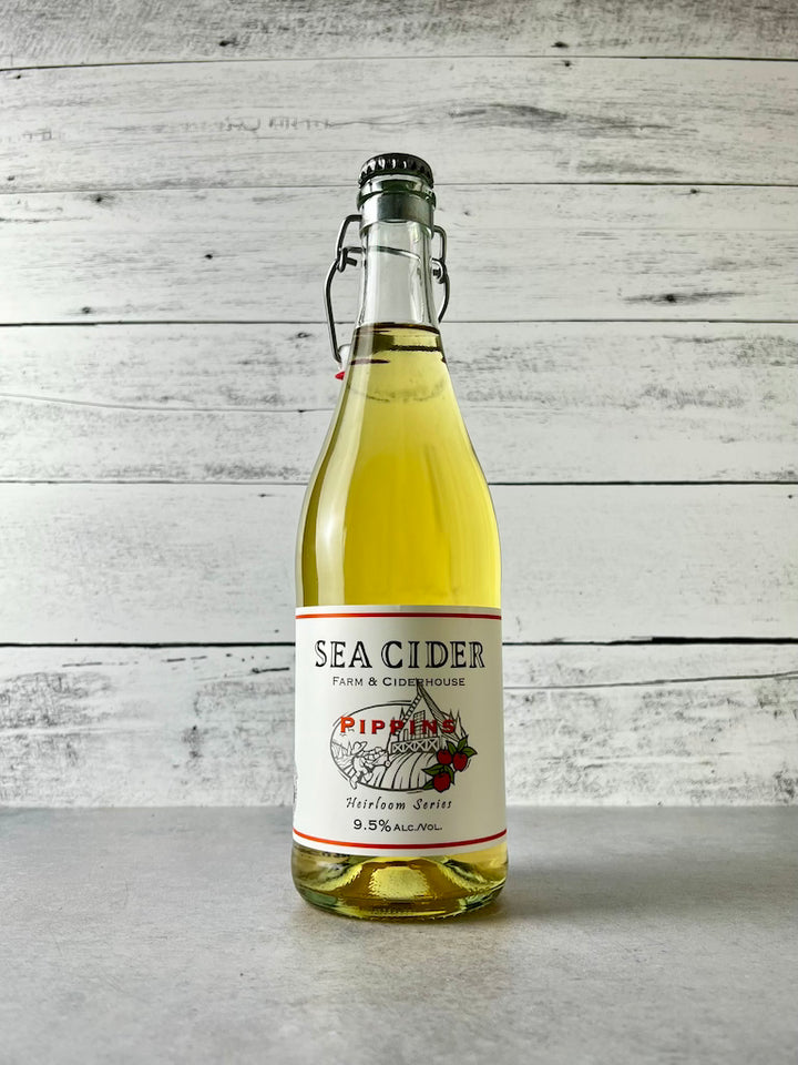 750 mL clear glass bottle of Sea Cider Farm & Ciderhouse Pippins Heirloom Series cider with flip-top