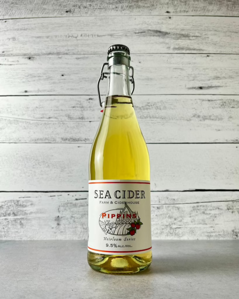 750 mL clear glass bottle of Sea Cider Farm & Ciderhouse Pippins Heirloom Series cider with flip-top