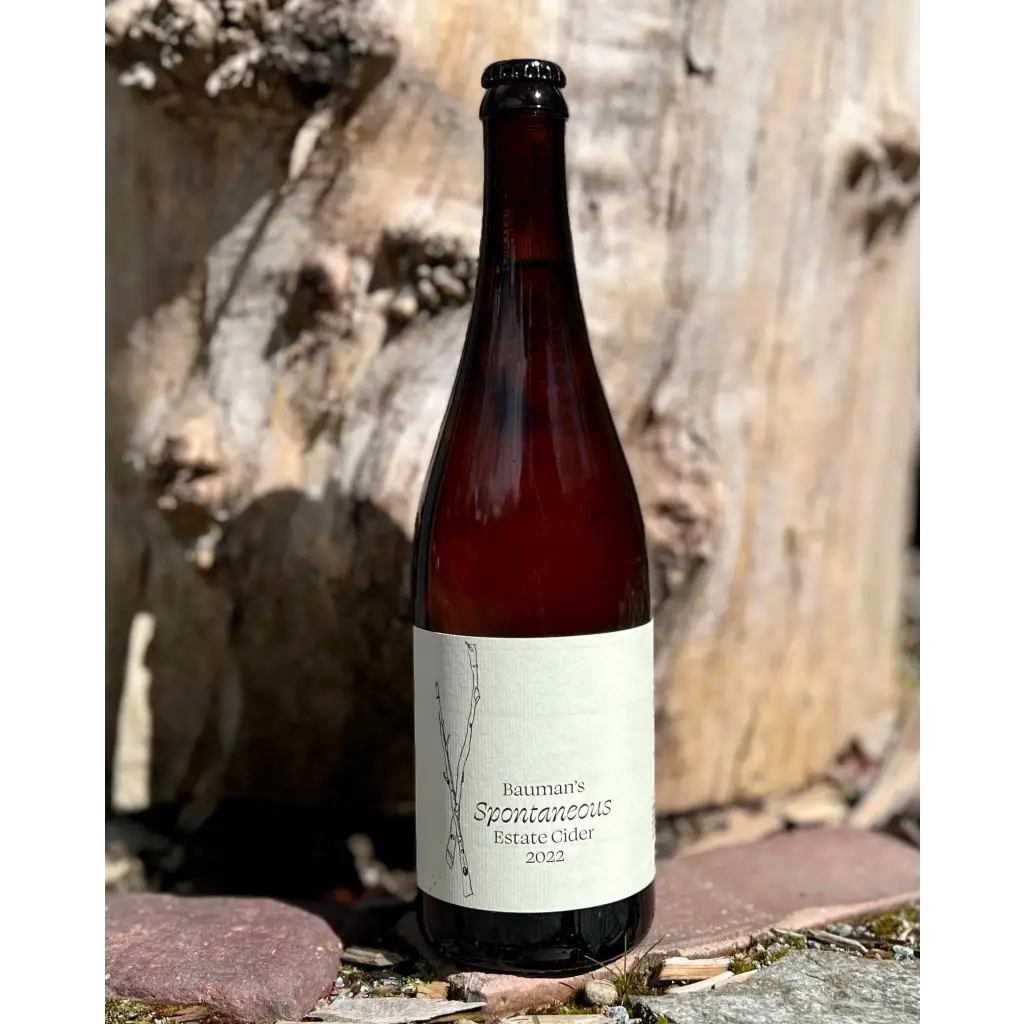 750 mL brown glass bottle of Bauman's Spontaneous Estate Cider 2022