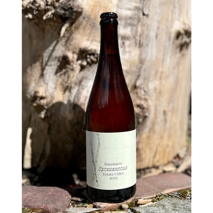 750 mL brown glass bottle of Bauman's Spontaneous Estate Cider 2022