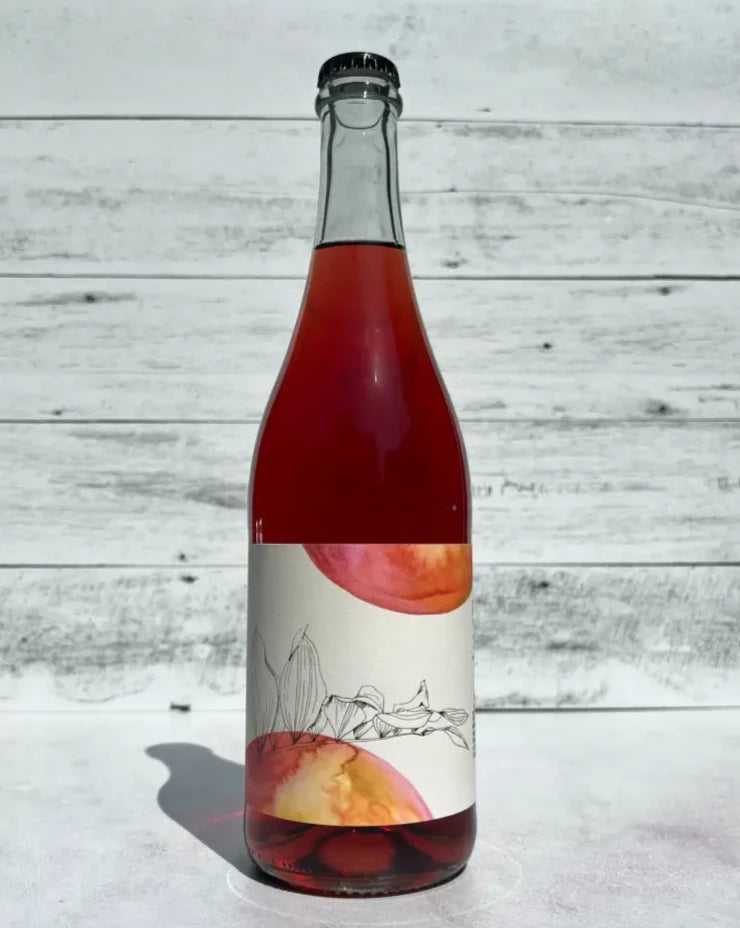 750 mL clear glass bottle of bright pink colored Bauman's Cider Forbidden Fruit Rosé Pinot Noir coferment cider