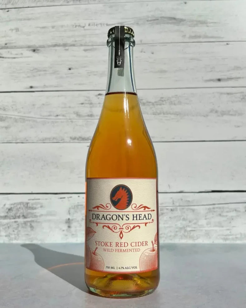 750 mL clear glass bottle of light pink Dragon's Head Stoke Red Cider - Wild Fermented