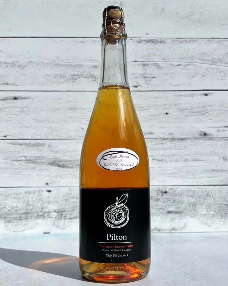 750 mL bottle of Pilton Somerset Keeved Cider with cork and cage top