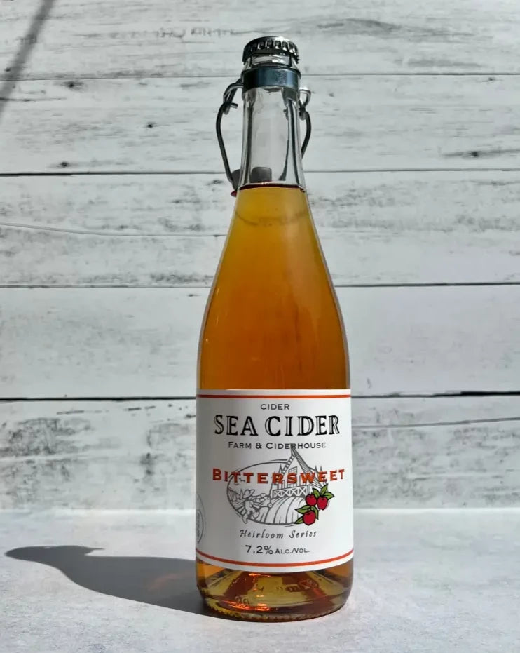 750 mL clear glass bottle of Sea Cider Farm & Ciderhouse Bittersweet Heirloom Series cider with flip top